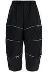 COMME DES GARCONS BLACK cropped pants with zip openings.