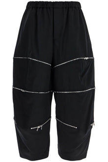  COMME DES GARCONS BLACK cropped pants with zip openings.