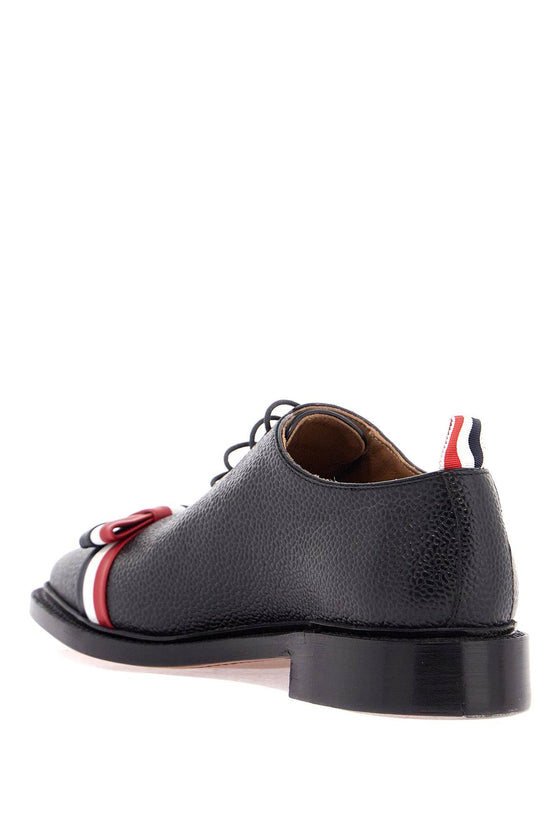 Thom Browne elegant wholecut shoes in black calfskin with rwb bow